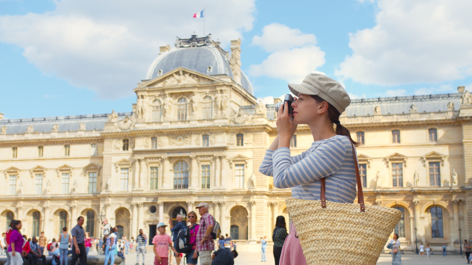 Young tourist with a retro camera in Paris